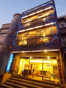 a building with lights on the side of it at Ibizakenting Hotel II in Kenting