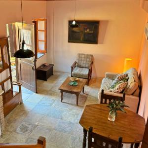 a living room with a couch and a table at Eveleos Country House in Tochni