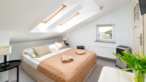 a bedroom with a bed with two shoes on it at Willa Celina in Karpacz