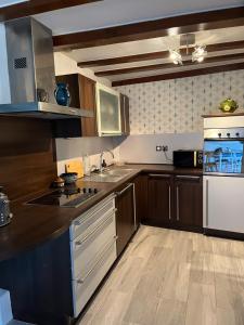 a kitchen with a sink and a stove top oven at Le petit nid de Turckheim avec parking privé in Turckheim