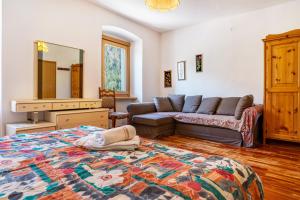 a living room with a bed and a couch at Casa Ai Laresi 1 in Peio