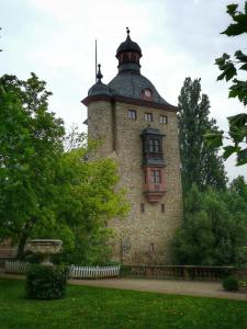 a large brick building with a clock tower at Rosi's Kuschelapartment in Geisenheim +11 photos