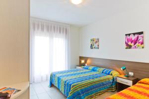 Postel nebo postele na pokoji v ubytování Residence Galleria Gran Madò + 12 fotografií