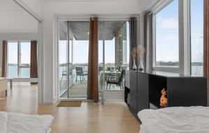 a living room with a fireplace and a dining room at Beautiful Apartment In Gråsten in Gråsten