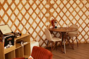 a room with a table and chairs in a yurt at Glamping Le Dune in Cinigiano