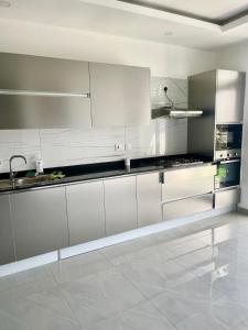 eine Küche mit weißen Schränken und einer Spüle in der Unterkunft Aqua Luxury homes in Mombasa