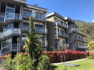 an apartment building with balconies and a garden at Alexandra's Superior Apartments in Domaso