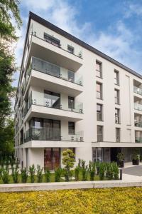 an exterior view of a white apartment building at Metropolis Design Apartments in Kraków