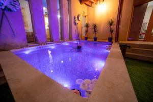 a swimming pool with purple lights in a building at Castillo Fortaleza de Ateca in Ateca