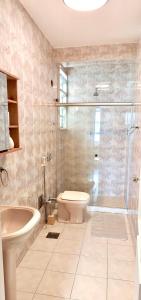 a bathroom with a shower and a toilet and a sink at Pão de Açúcar in Rio de Janeiro +38 photos