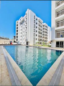 ein großes Schwimmbad vor einem Gebäude in der Unterkunft Aqua Luxury homes in Mombasa