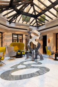 a lobby with a sculpture in the middle of a room at Le Burgundy Paris in Paris