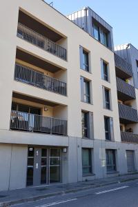 an apartment building with balconies on a street at Sahara - appartement ensoleillé au cœur de Reims in Reims