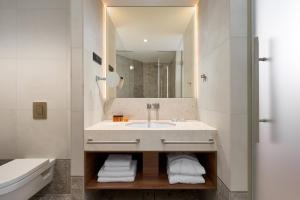 a bathroom with a sink and a mirror at Grand Hotel View in Postira