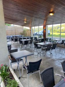 a group of tables and chairs in a patio at Auberge de la Source in Chazey-Bons