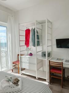 a bedroom with a white dresser and a desk at Hotel Maremola in Pietra Ligure +112 photos