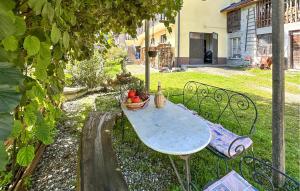 a table and chairs with a basket of fruit on it at Lovely Apartment In Lamon With Wifi in Lamon +23 photos