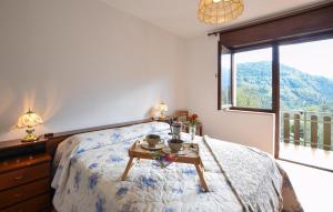 a bedroom with a bed with a table on it at Lovely Apartment In Lamon With Wifi in Lamon