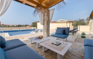 a patio with blue furniture and a swimming pool at Villa Kalista Istriana in Pula
