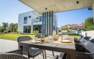 a table and chairs on a patio in front of a building at Villa Mia Stella in Štanga