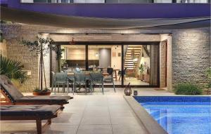 a living room with a swimming pool and a house at Villa Monte Grosso in Pula