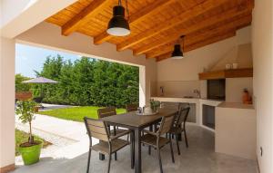 a kitchen and dining room with a table and chairs at Villa Rita in Bašići +38 photos