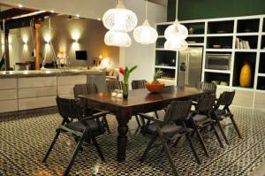 a dining room table with chairs and a kitchen at Los Patios Hotel Granada in Granada