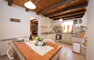 a kitchen with a wooden table with flowers on it at Gorgeous Home In Poljane With Sauna in Ružići