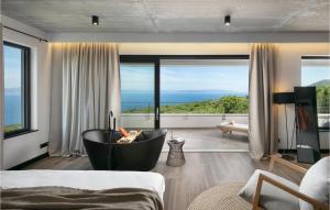 a bedroom with a tub and a view of the ocean at Villa The View in Sveta Marina