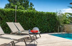 two chairs and a table next to a pool at Villa Hello Sunshine in Poreč +52 photos
