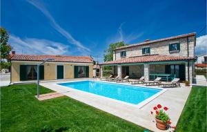 a villa with a swimming pool in front of a house at Villa Luca in Radetići