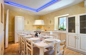 a dining room with a table and chairs in a kitchen at Villa Luca in Radetići
