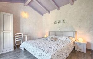 a bedroom with a bed and two tables and a chair at Villa Luca in Radetići