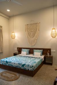 a bedroom with a bed with blue and white sheets at Triton Dondra in Dondra West