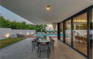 a patio with a table and chairs and a pool at Villa Eleven in Rovinj +52 photos