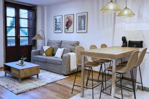 a living room with a table and a couch at Apartamentos centro Vilagarcía in Vilagarcia de Arousa