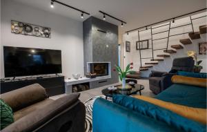 a living room with blue couches and a tv at Villa Carlotta in Vižinada