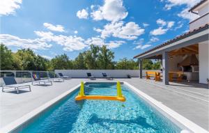 a pool with a slide on a patio with chairs at Villa Casa Mara in Pula