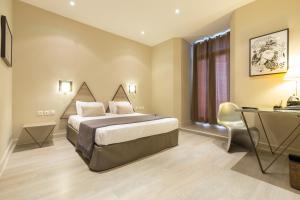 een hotelkamer met een bed en een bureau bij Hôtel Amirauté in Toulon