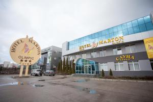 a large building with a clock in front of it at Marton Olimpic in Kaliningrad