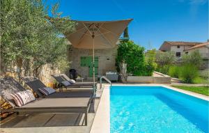 a swimming pool with lounge chairs and an umbrella at Villa Kalu in Rovinj +41 photos