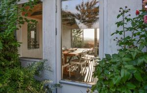 an open door to a patio with a table and chairs at 2 Bedroom Beautiful Home In Glemmingbro in Hammar