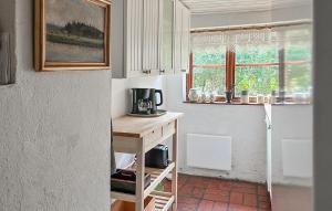 a kitchen with a table with a coffee maker on it at 2 Bedroom Beautiful Home In Glemmingbro in Hammar