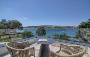 a balcony with a table and chairs and a view of the water at Villa Lunjsko in Stara Novalja +40 photos