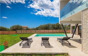 a patio with two chairs and a swimming pool at Villa Ogradina in Pula