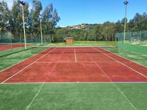 a tennis court with a red and green at AHR Costa Serena Village in Palau