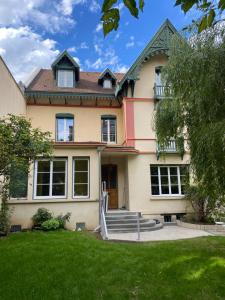 a large house with a lawn in front of it at La Villa Chorier in Grenoble