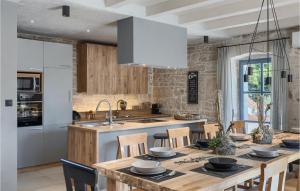 a kitchen with a large wooden table with chairs at Villa Pi in Brečevići