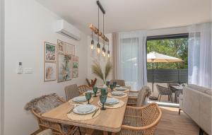 a dining room with a wooden table and chairs at Cozy Home In Srima With Wifi in Srima