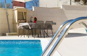 a patio with a table and chairs next to a swimming pool at Villa Miceli in Pula